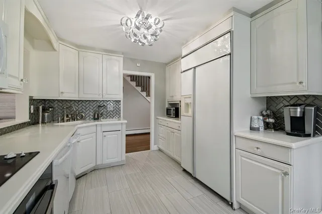 a kitchen with stainless steel appliances a refrigerator sink and cabinets