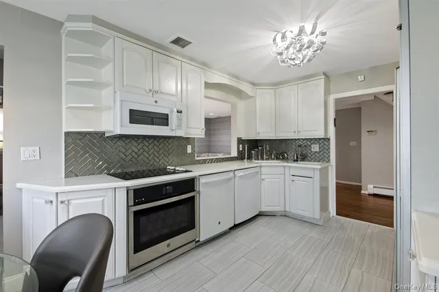 a kitchen with granite countertop a stove a sink and a refrigerator