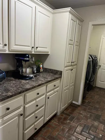 a kitchen with granite countertop a sink and a stove top oven