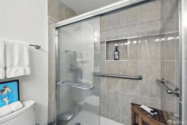 a bathroom with a shower and toilet
