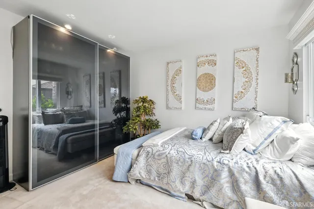 a bedroom with a bed and glass door