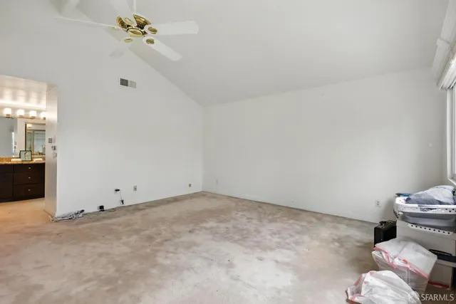 a view of a room with a ceiling fan and a bathroom