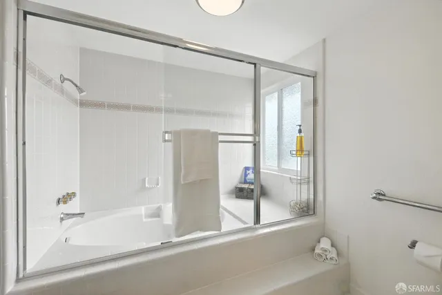 a bathroom with a bathtub and a shower