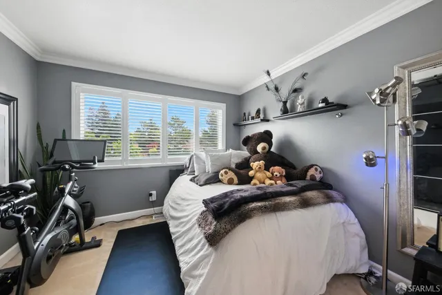 a bed room with a bed and a large window