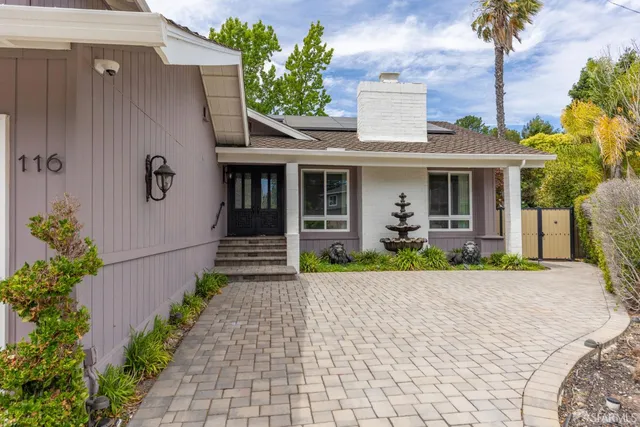 a front view of a house with garden
