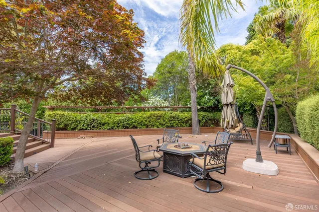 a view of a backyard with sitting area