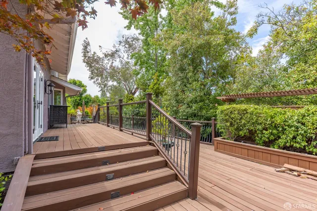 a view of a patio with wooden floor and fence