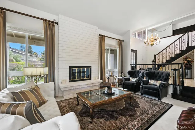 a living room with furniture coffee table and a fireplace
