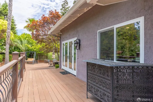 a view of a house with backyard and sitting area