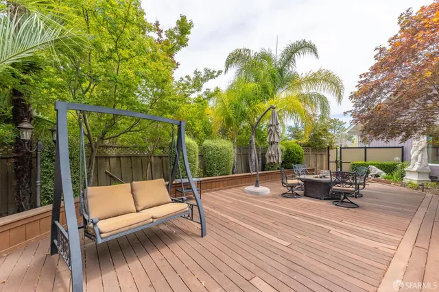 a view of a patio with a table and chairs