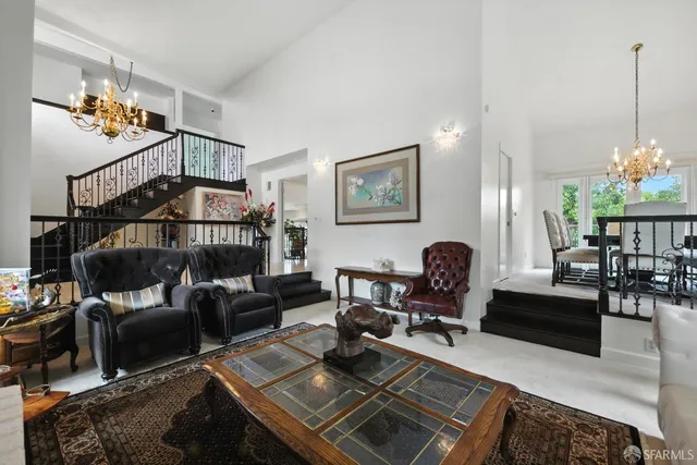 a living room with furniture and a chandelier