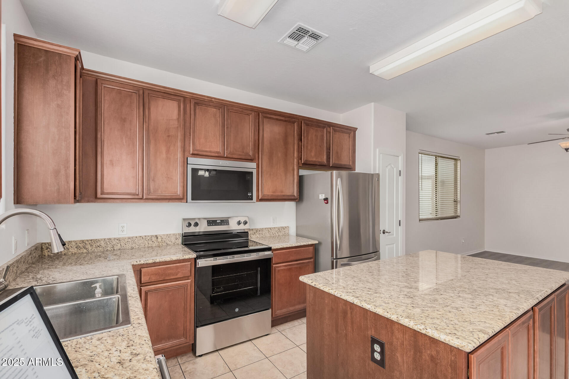 14784 West Riviera Drive Surprise, AZ 85379 - Photo 11 of 28 a kitchen with stainless steel appliances granite countertop a sink stove and refrigerator