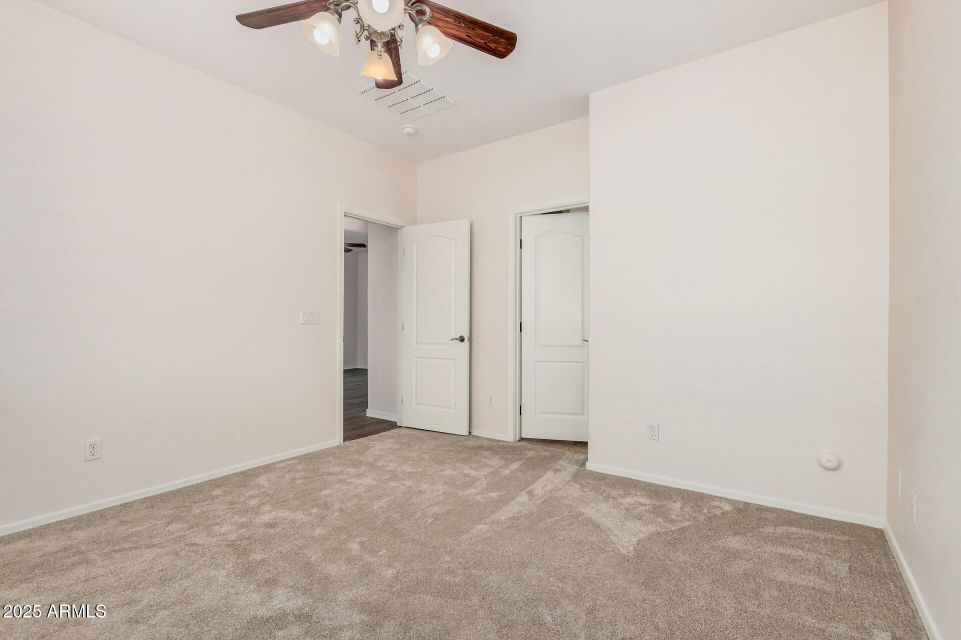 14784 West Riviera Drive Surprise, AZ 85379 - Photo 14 of 28 an empty room with a fan and a chandelier fan