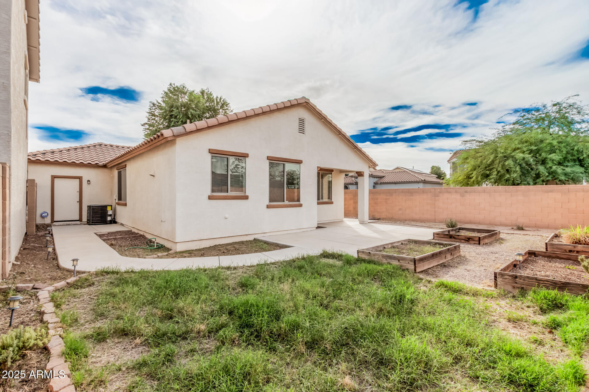 14784 West Riviera Drive Surprise, AZ 85379 - Photo 26 of 28 a backyard of a house with table and chairs
