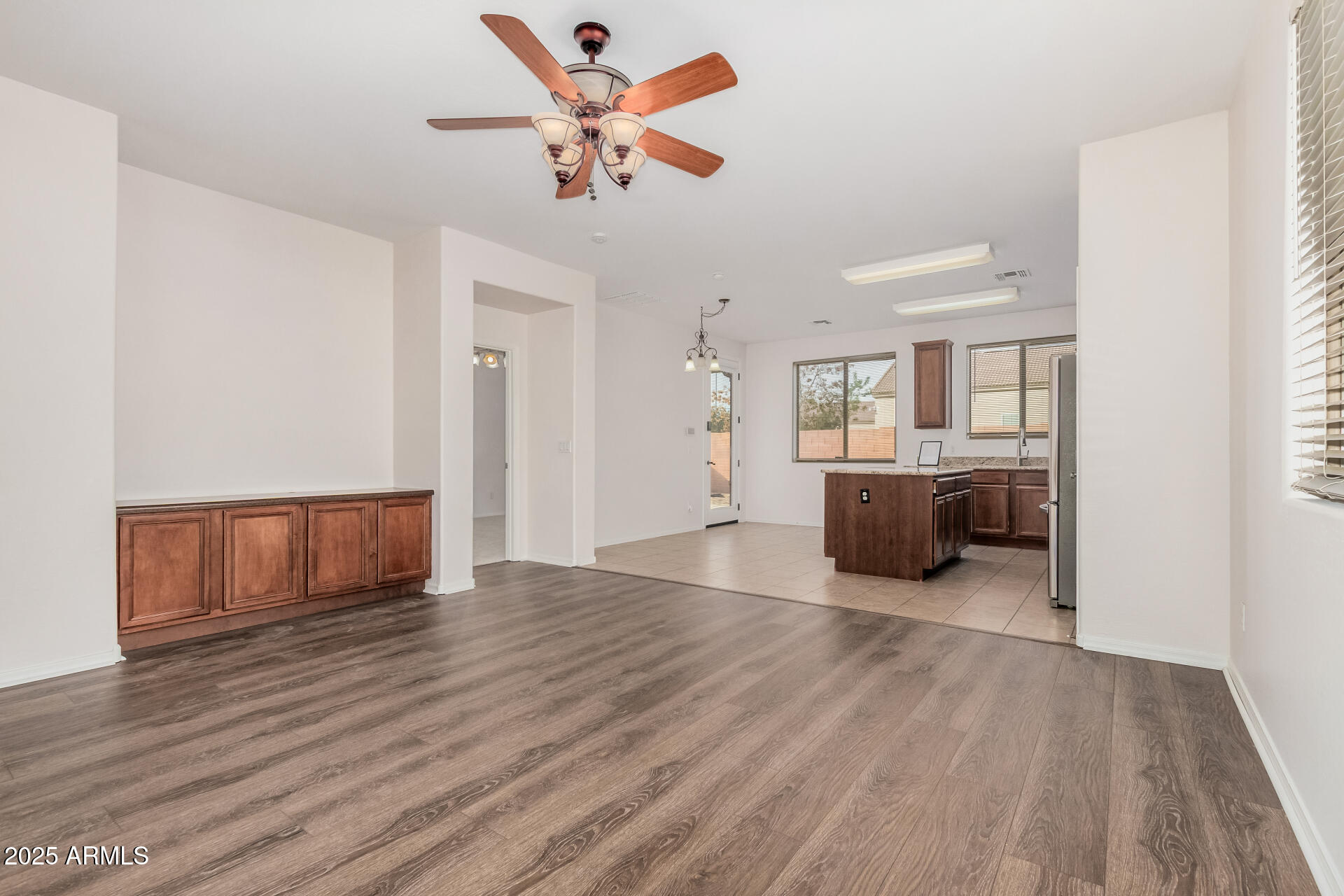 14784 West Riviera Drive Surprise, AZ 85379 - Photo 5 of 28 a view of a livingroom with wooden floor and a ceiling fan