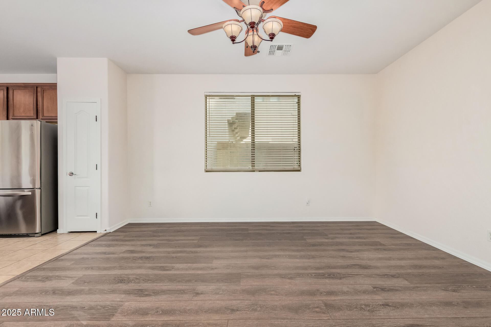 14784 West Riviera Drive Surprise, AZ 85379 - Photo 6 of 28 wooden floor in an empty room with a window