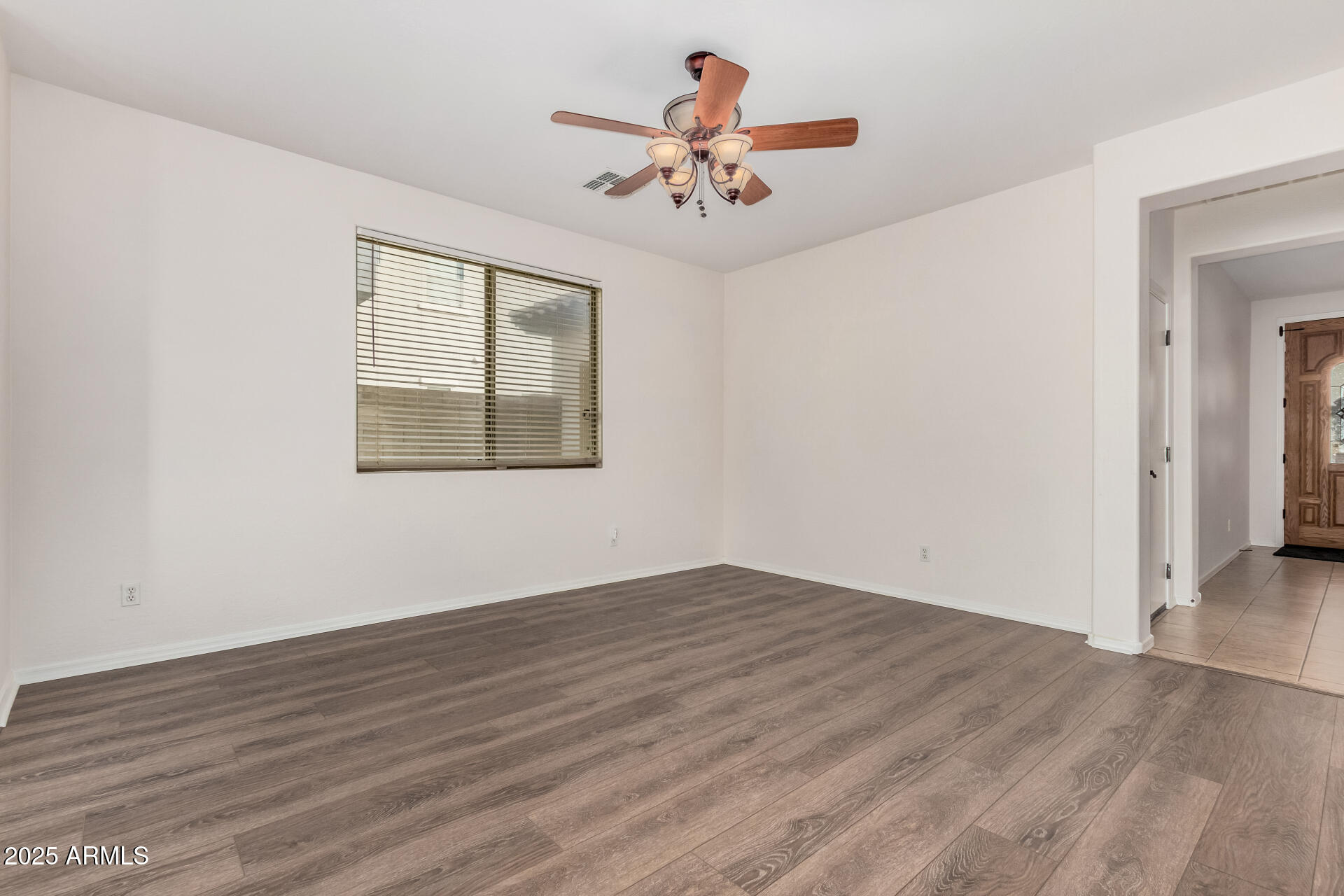 14784 West Riviera Drive Surprise, AZ 85379 - Photo 7 of 28 wooden floor in an empty room with a window