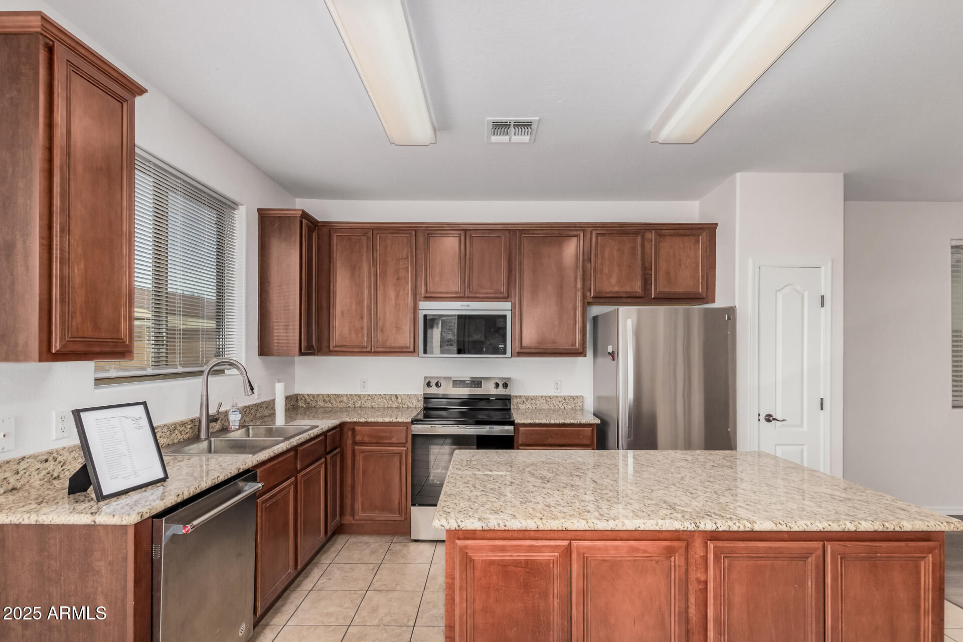 14784 West Riviera Drive Surprise, AZ 85379 - Photo 10 of 28 a kitchen with granite countertop a refrigerator and a sink