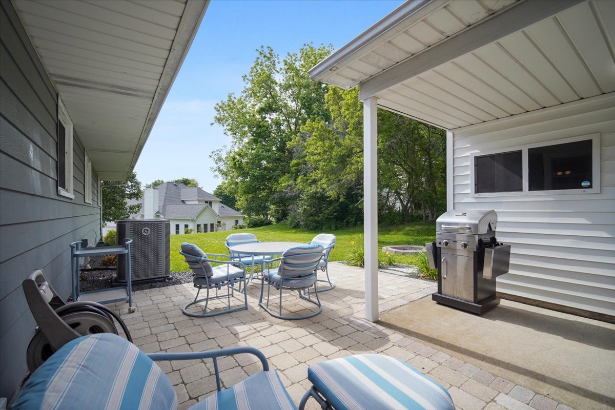 203 Highview Drive Eureka, IL 61530 - Photo 40 of 49 a view of a patio with table and chairs potted plants with wooden floor and fence