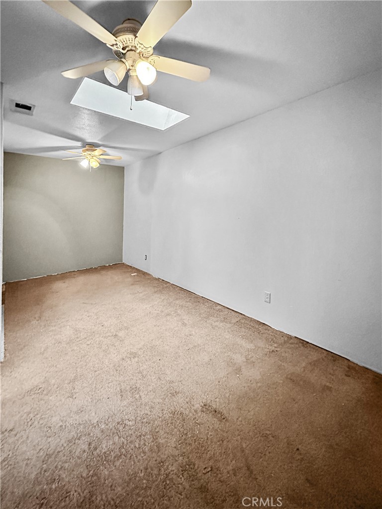 15 Regent Loop Oroville, CA 95966 - Photo 17 of 22 an empty room with a fan & a ceiling fan