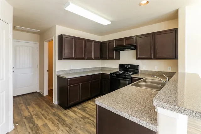 a kitchen with granite countertop cabinets and stainless steel appliances