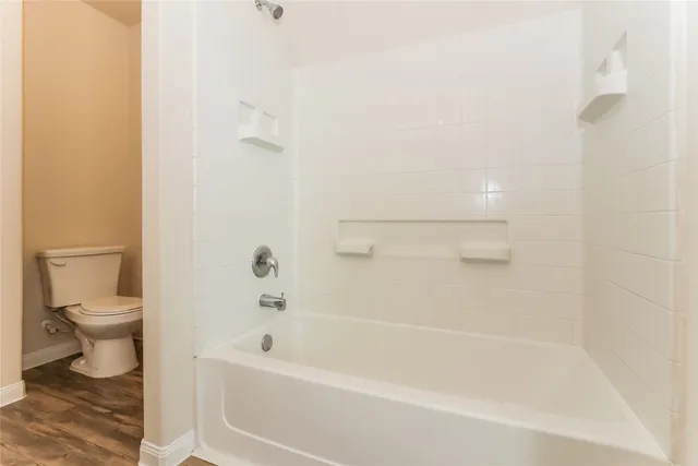 a bathroom with a bathtub and a toilet