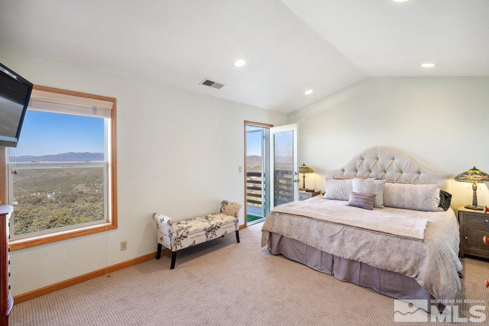 2045 Flint Road Reno, NV 89521 - Photo 14 of 33 a spacious bedroom with a bed and a window