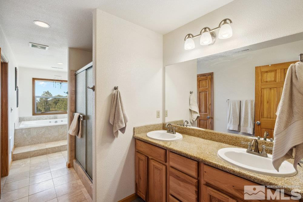 2045 Flint Road Reno, NV 89521 - Photo 18 of 33 a bathroom with a double vanity sink and mirror