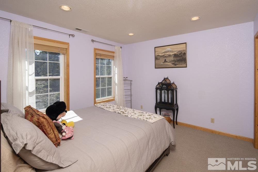 2045 Flint Road Reno, NV 89521 - Photo 20 of 33 a bedroom with a bed and wooden floor