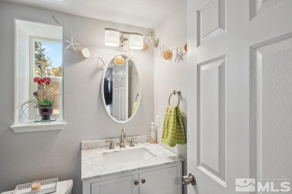 2045 Flint Road Reno, NV 89521 - Photo 27 of 33 a bathroom with a sink vanity and mirror