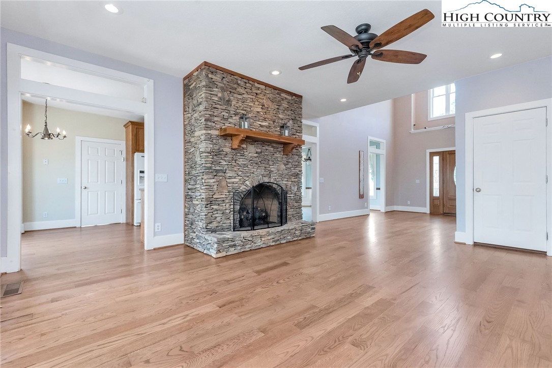 51 Horton Road Ennice, NC 28623 - Photo 25 of 44 a view of a livingroom with a fireplace a ceiling fan and wooden floor