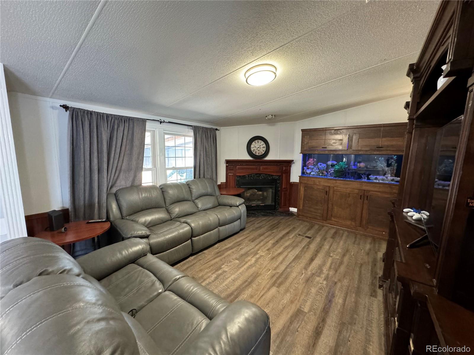 1921 Quintero Street Aurora, CO 80011 - Photo 11 of 18 a living room with furniture and a fireplace