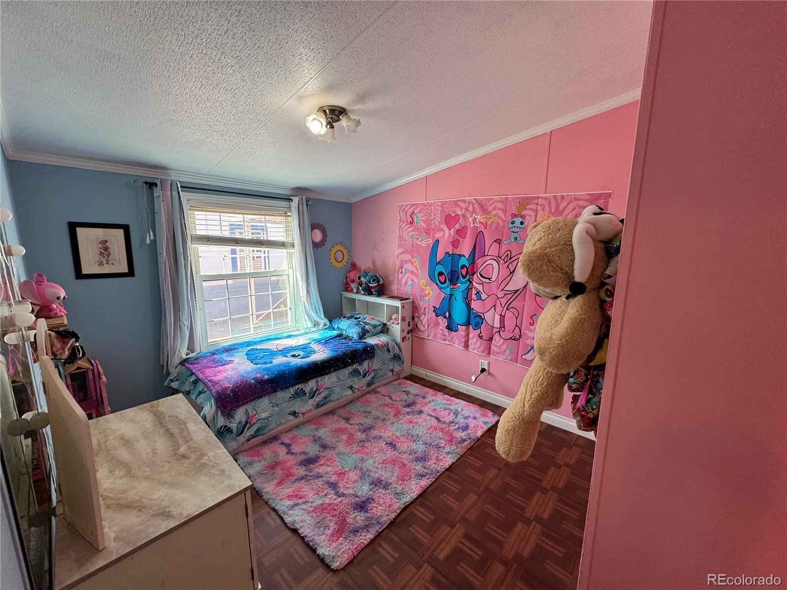 1921 Quintero Street Aurora, CO 80011 - Photo 13 of 18 a bed room with a bed and a couch