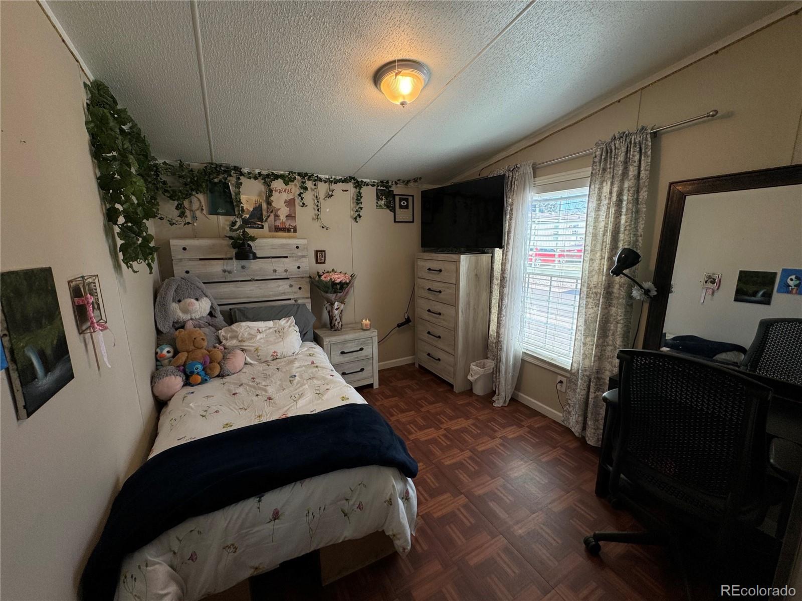 1921 Quintero Street Aurora, CO 80011 - Photo 16 of 18 a bedroom with furniture and a window