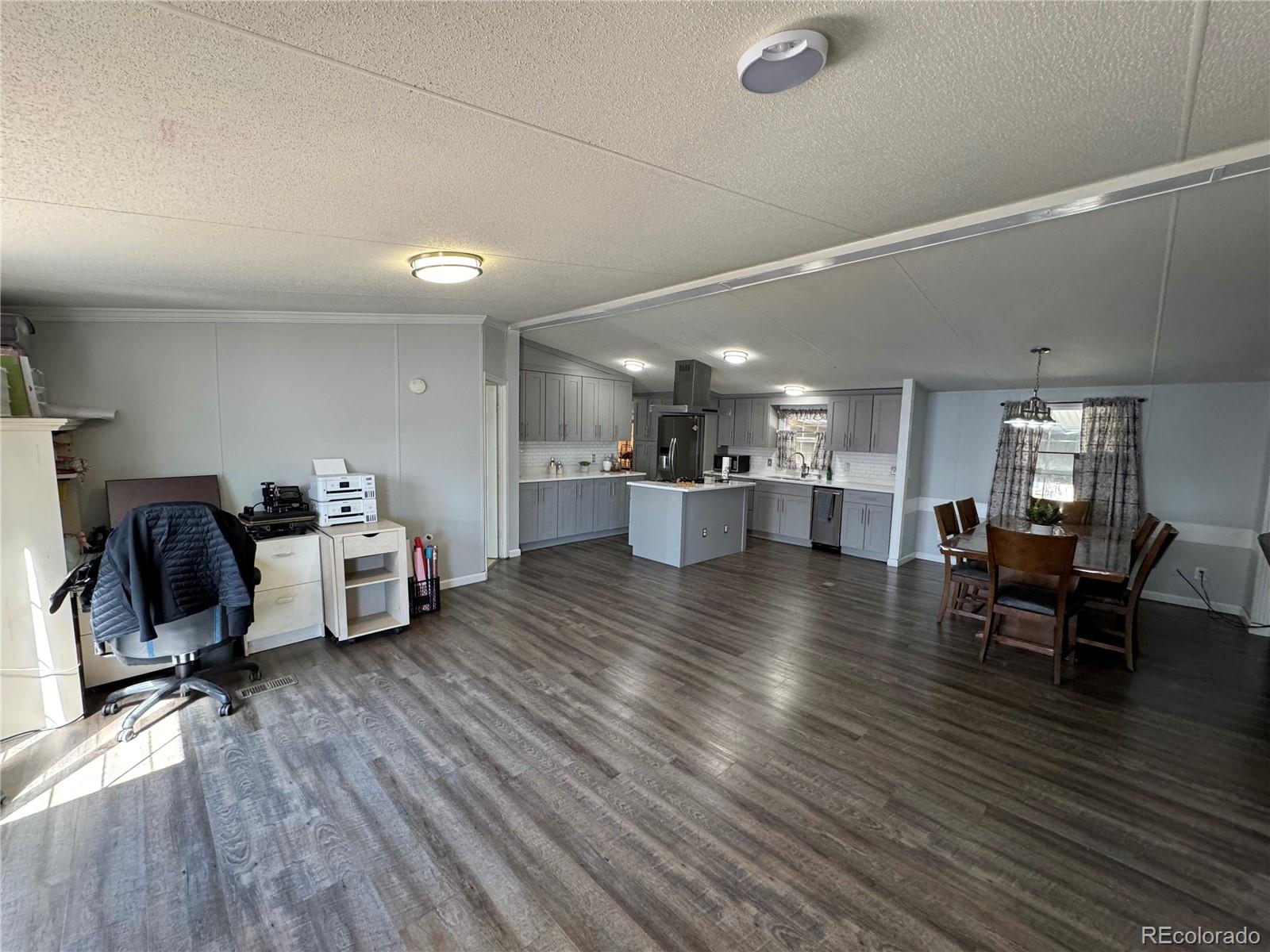 1921 Quintero Street Aurora, CO 80011 - Photo 4 of 18 a view of a living room and dining room