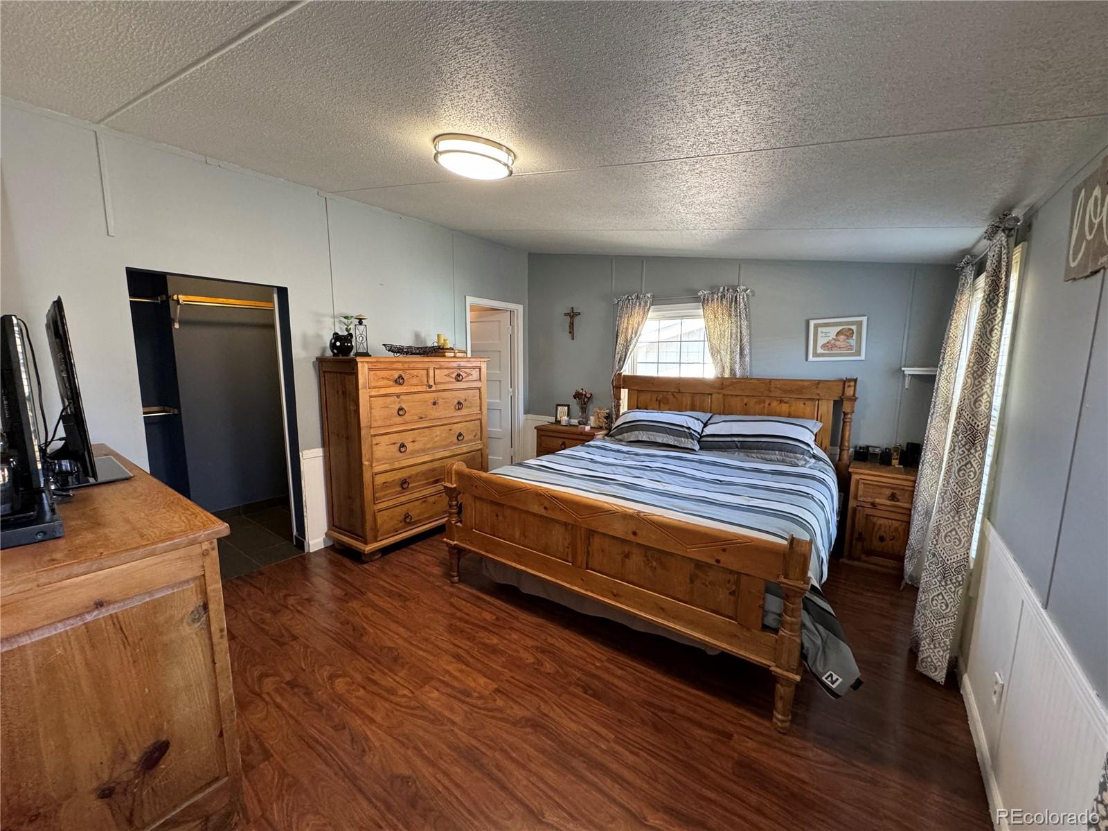 1921 Quintero Street Aurora, CO 80011 - Photo 9 of 18 a bedroom with a bed and a refrigerator