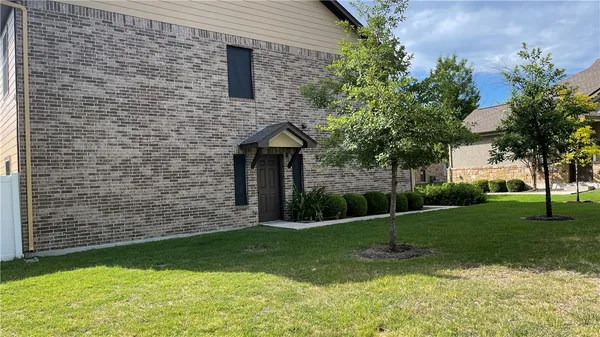 a brick building with a yard