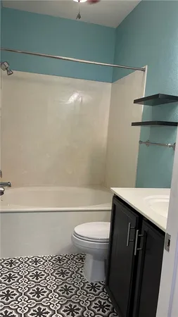 a bathroom with a toilet a sink and bathtub