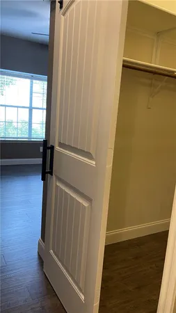 a view of a room with wooden floor and a window