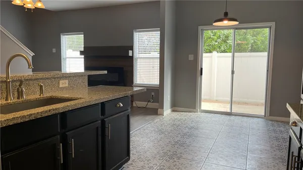 a kitchen with a sink a counter top space and cabinets