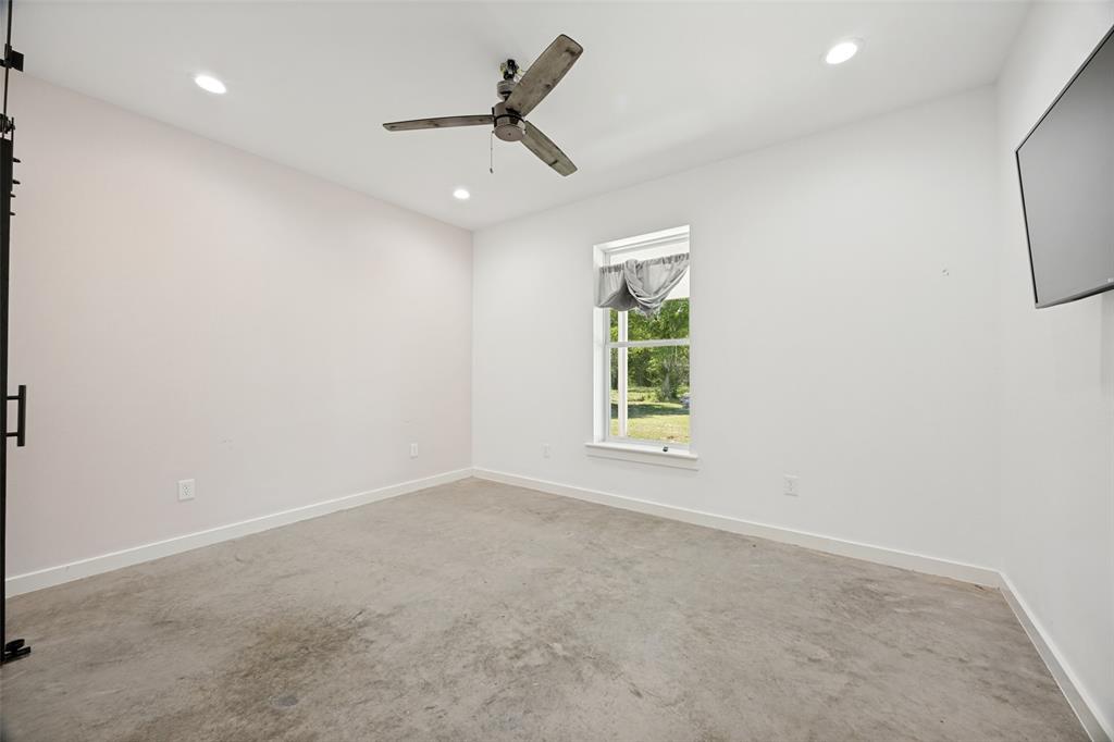 822 Private Road 7370 Point, TX 75472 - Photo 24 of 30 Interior room featuring a ceiling fan, recessed lighting, concrete flooring, and a single window with outdoor scenery