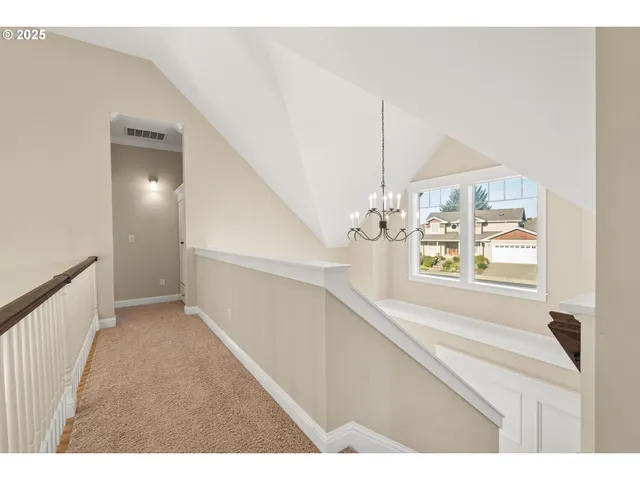 a view of backyard with potted plants and wooden fence