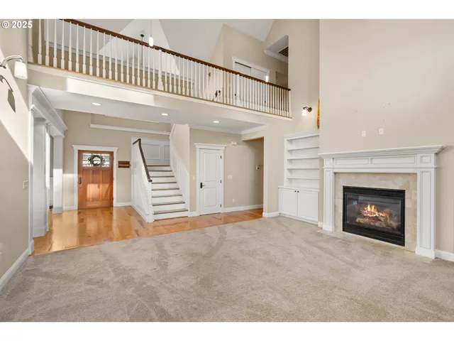 a view of a hallway view with wooden floor and staircase