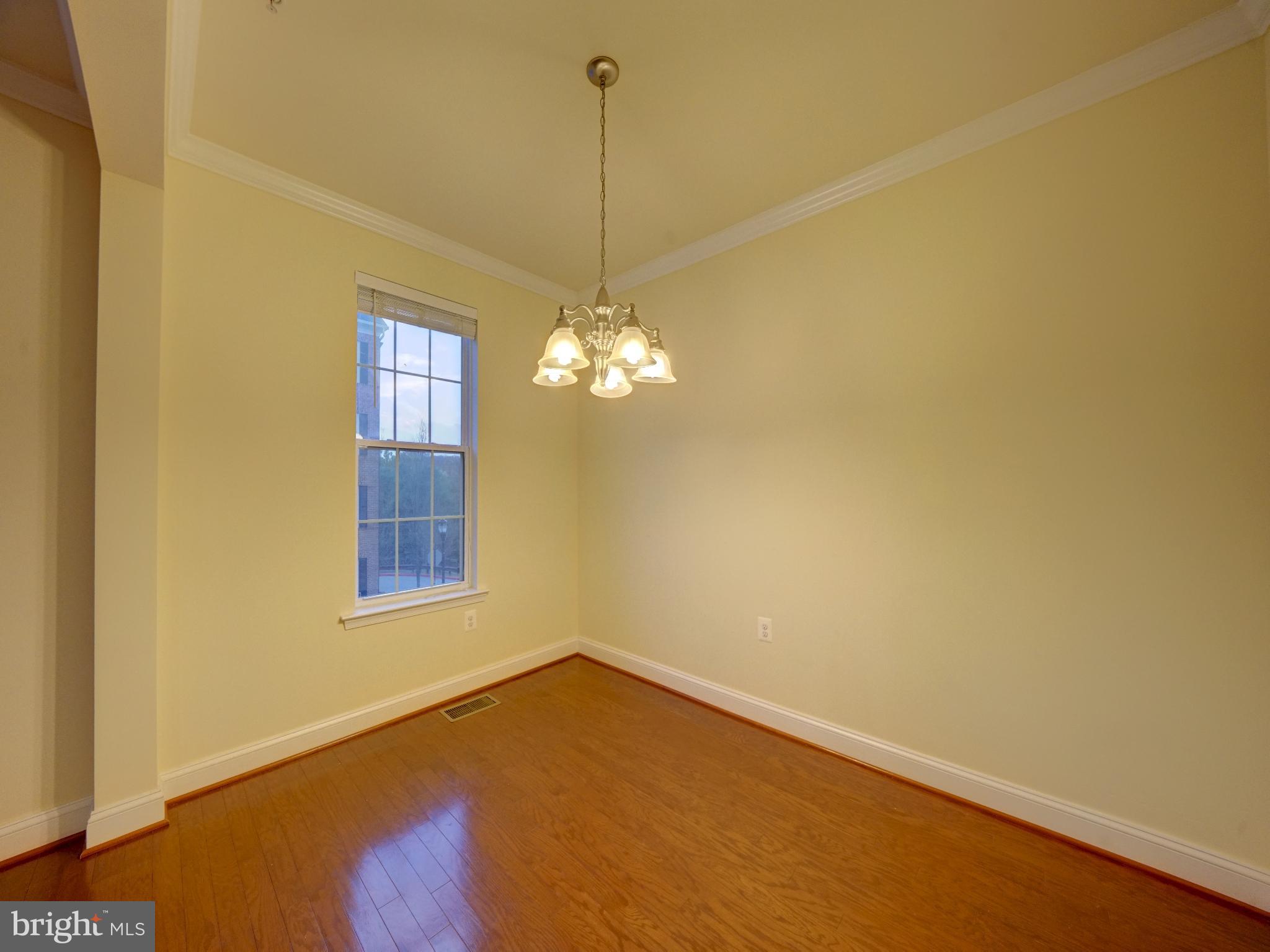 11205 Chase Street, Unit 63 Fulton, MD 20759 - Photo 13 of 22 a view of a room that has a window and wooden floor