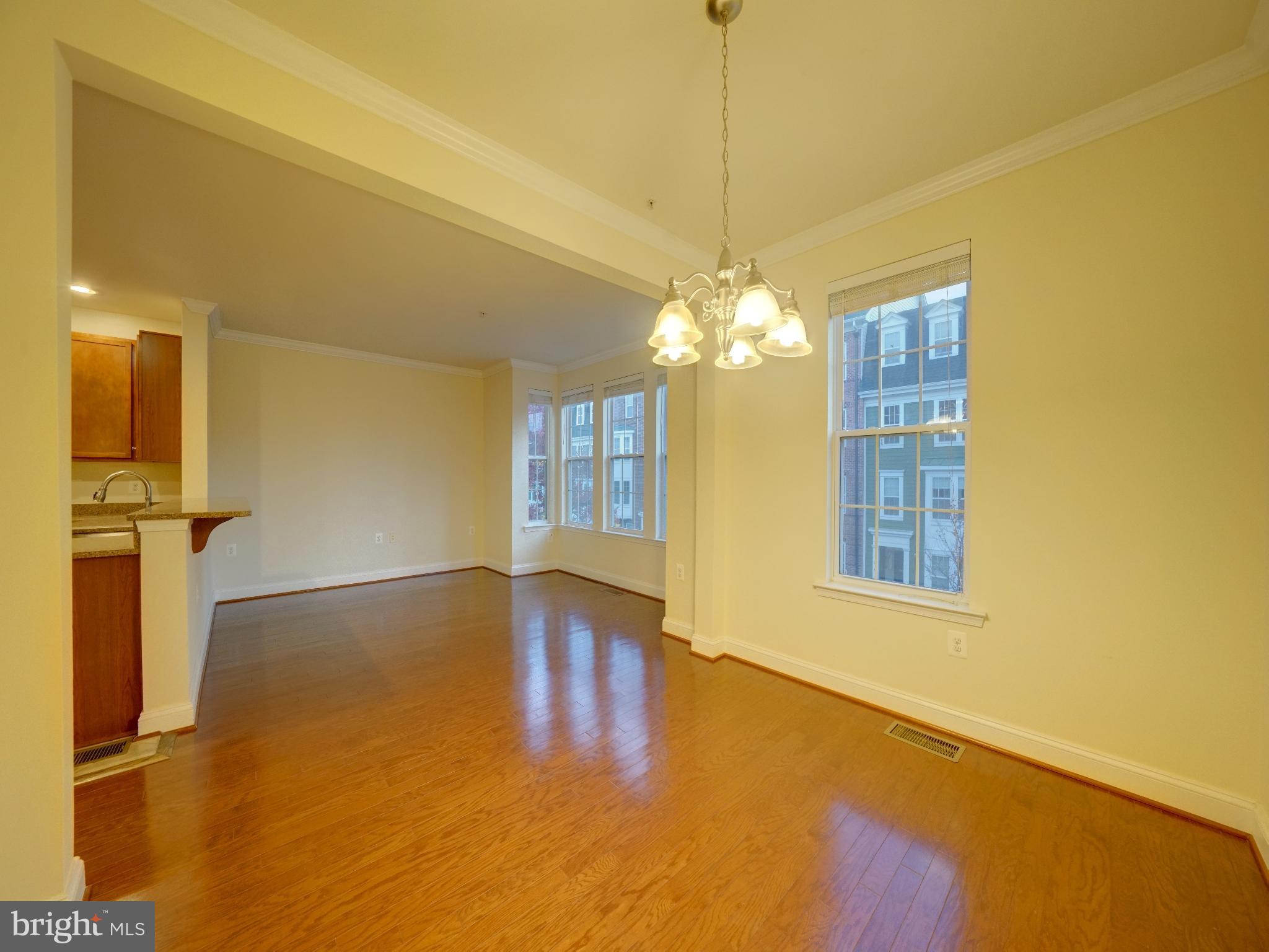 11205 Chase Street, Unit 63 Fulton, MD 20759 - Photo 14 of 22 a view of an empty room with chandelier and a window
