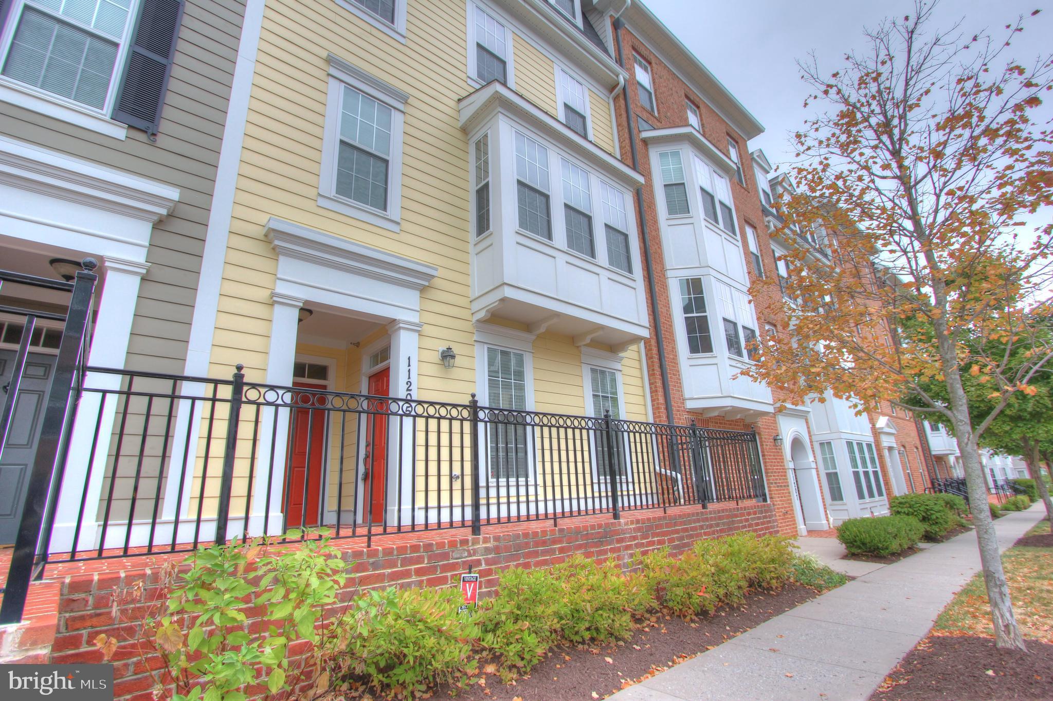 11205 Chase Street, Unit 63 Fulton, MD 20759 - Photo 2 of 22 a view of a brick building next to a yard