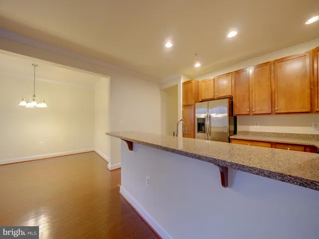 a large kitchen with kitchen island a sink stainless steel appliances and cabinets