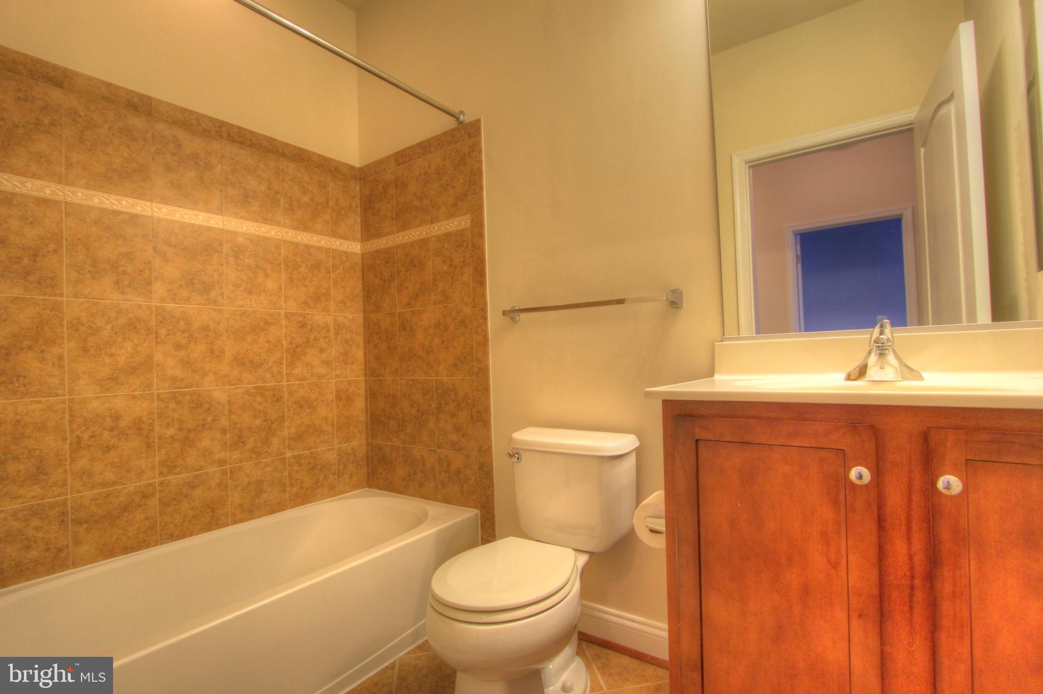 11205 Chase Street, Unit 63 Fulton, MD 20759 - Photo 10 of 22 a bathroom with a sink toilet and shower