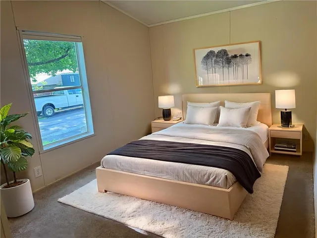 a bedroom with a bed and a potted plant