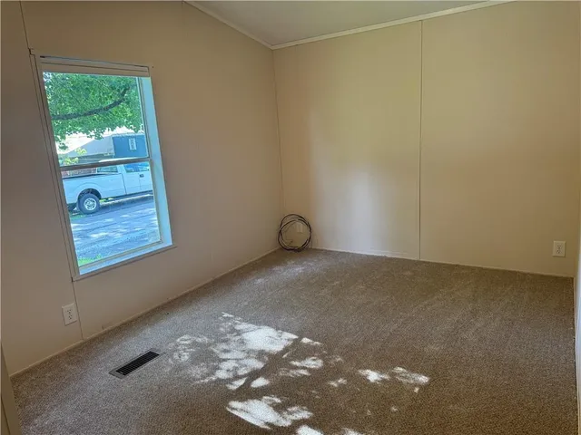 a view of room with window and wooden floor